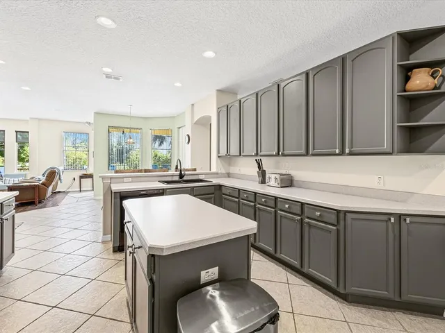 a kitchen with a sink cabinets and window