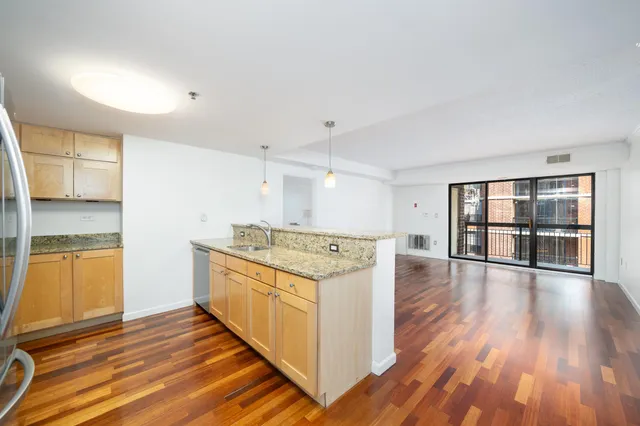 a kitchen with stainless steel appliances granite countertop a stove and a refrigerator