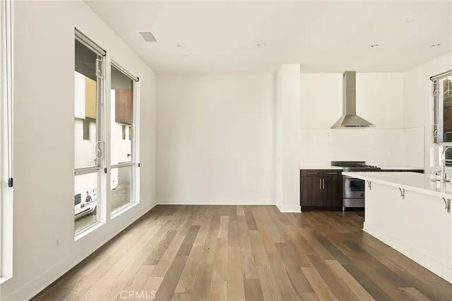 a view of kitchen with wooden floor and electronic appliances
