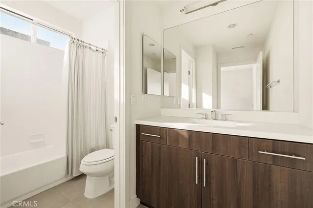 a bathroom with a double vanity sink toilet and shower