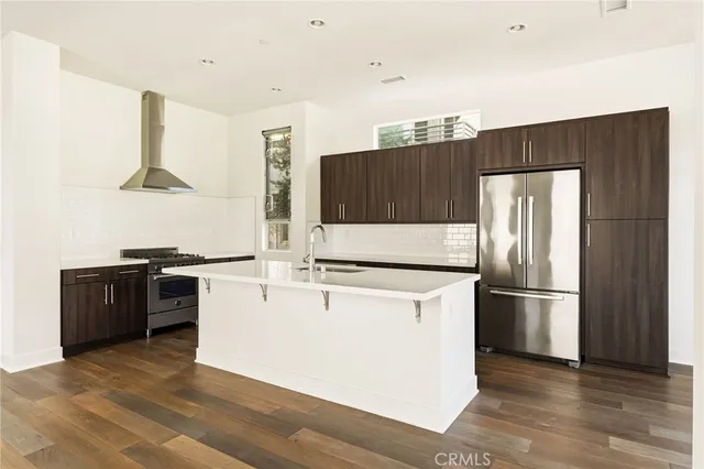 a kitchen with stainless steel appliances a refrigerator and a stove