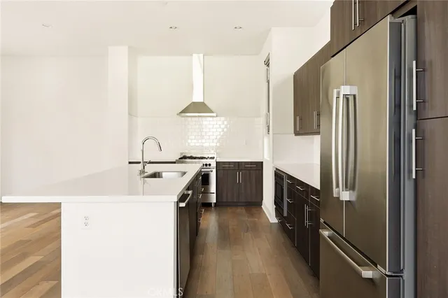 a kitchen with stainless steel appliances a sink stove and refrigerator
