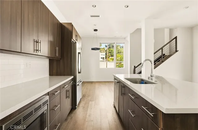 a kitchen with a sink a counter top space and cabinets