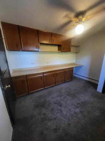a room with lots of wooden cabinets and outdoor space