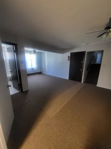 a view of a livingroom with a car parked in it