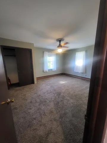 a view of an empty room with a fireplace