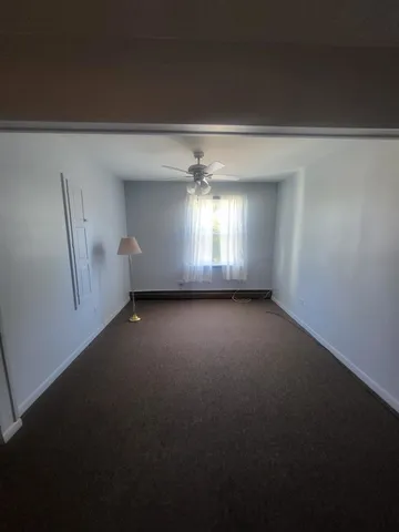 a view of room and hall with a window