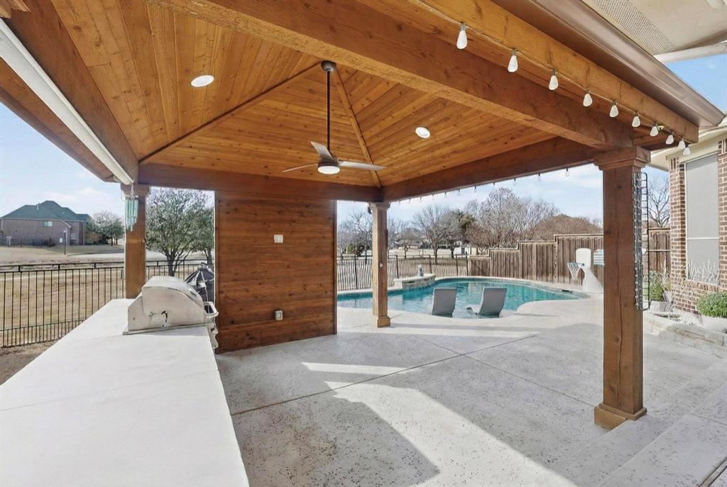 7625 Ridgedale Court Sachse, TX 75048 - Photo 35 of 40 AI, Fenced backyard with a patio and an outdoor kitchen