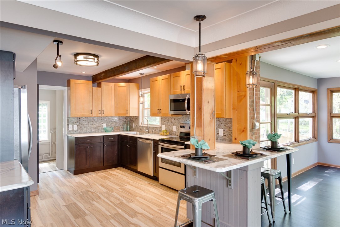 1046 Allston Road Cleveland Heights, OH 44121 - Photo 6 of 34 A custom Kitchen with a peninsula bar is perfect for every day and entertaining. Reclaimed wood is used on the columns, beams and peninsula base. This has an urban vibe, and note the steel beam in the Kitchen ceiling.