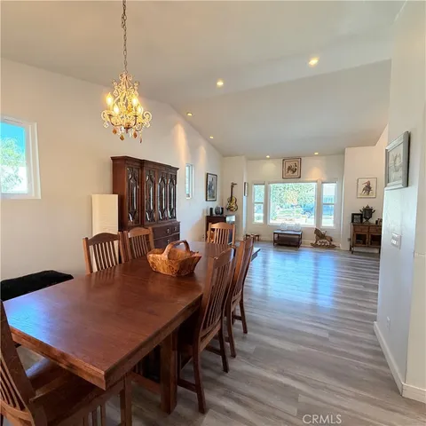 a view of a a dining room with furniture window and wooden floor