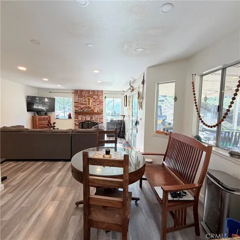 a dining room with furniture and wooden floor