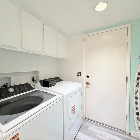 a view of a room with furniture and wooden floor