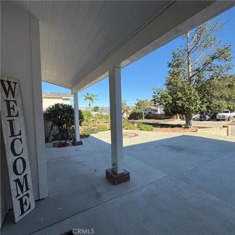 a view of a room with floor to ceiling windows and tree