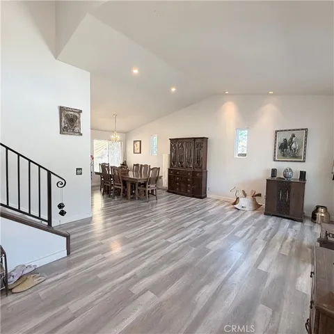 a view of a livingroom with wooden floor and stairs