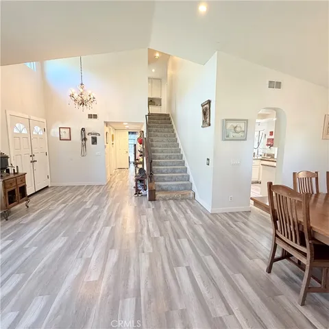 a view of a dining room with furniture wooden floor and a chandelier
