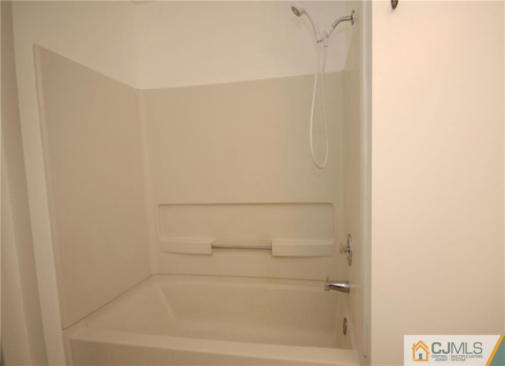 1037 Edpas Road, Unit 1037 New Brunswick, NJ 08901 - Photo 11 of 15 a close up of a bathtub