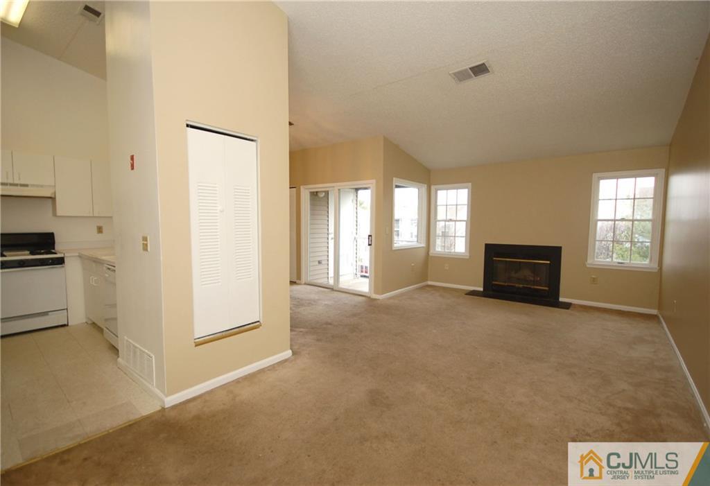 1037 Edpas Road, Unit 1037 New Brunswick, NJ 08901 - Photo 6 of 15 a view of an empty room with a window and fire place