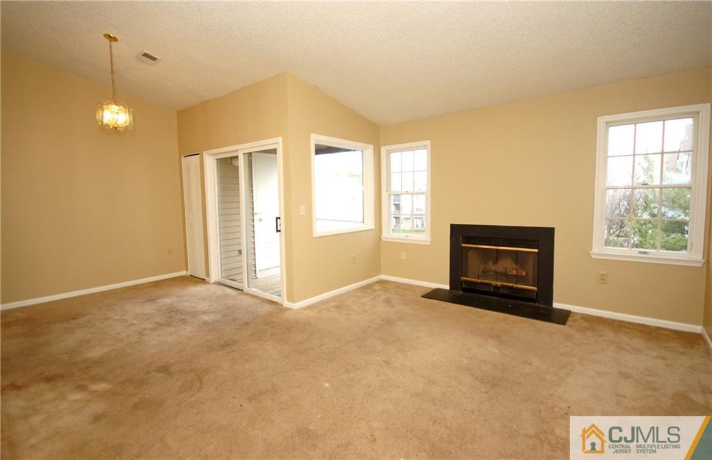 1037 Edpas Road, Unit 1037 New Brunswick, NJ 08901 - Photo 7 of 15 a view of an empty room with a window and a fireplace