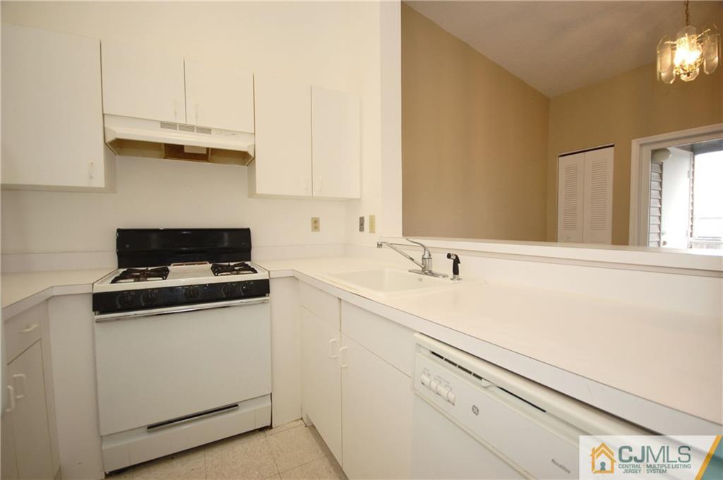 1037 Edpas Road, Unit 1037 New Brunswick, NJ 08901 - Photo 8 of 15 a kitchen with granite countertop white cabinets and white appliances