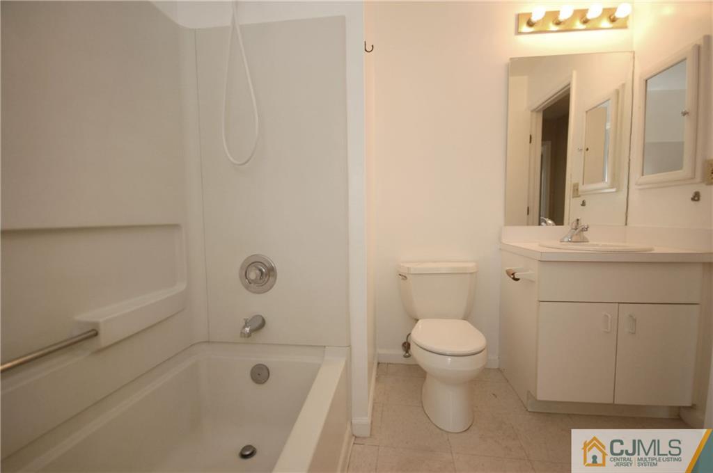 1037 Edpas Road, Unit 1037 New Brunswick, NJ 08901 - Photo 10 of 15 a bathroom with a toilet and a bathtub