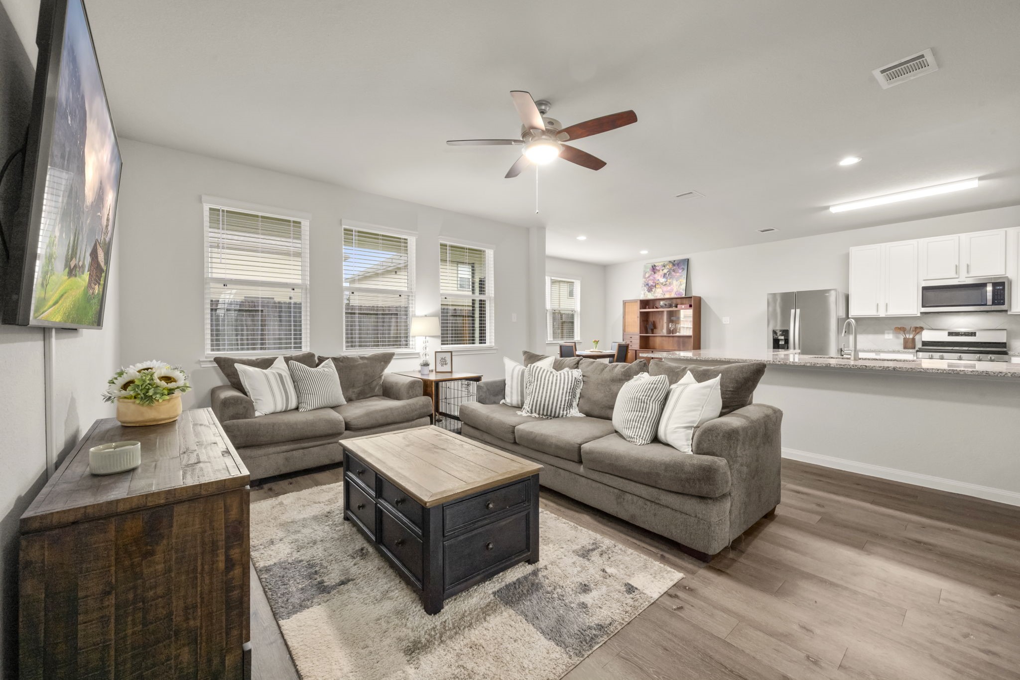 4915 Blue Jacaranda Way Spring, TX 77373 - Photo 5 of 30 The family room seamlessly connects to a contemporary kitchen offering an open feel while still maintaining separate spaces.