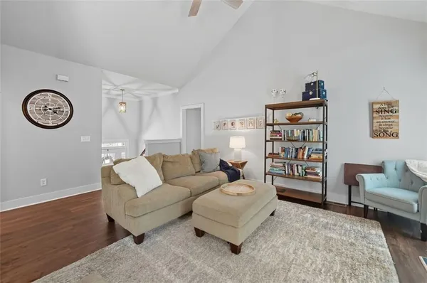 a living room with furniture a clock and a table