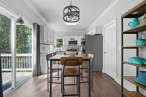 a view of a dining room with furniture window and wooden floor