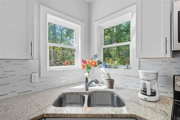 a kitchen with sink and window