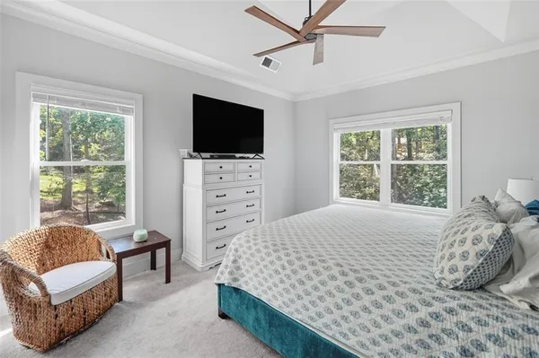 a bedroom with a bed a window and a television