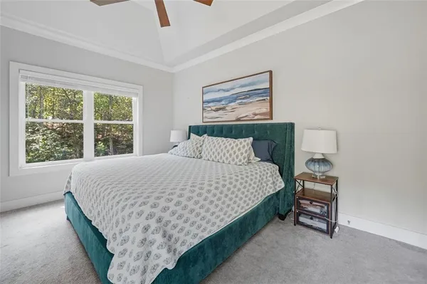 a bed sitting in a bedroom next to a window