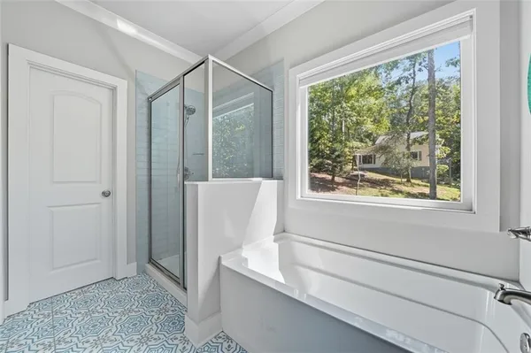 a bathroom with a bathtub and a window