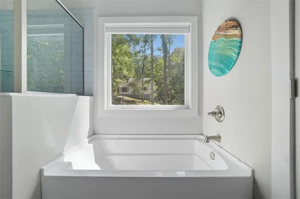 a bathroom with a tub and a window
