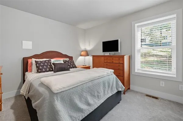 a bedroom with bed and a flat screen tv