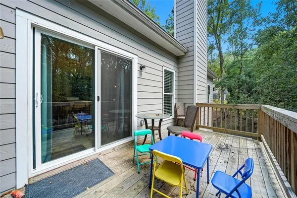 a balcony with table and chairs