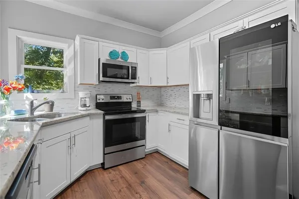 a kitchen with a sink and a stove top oven