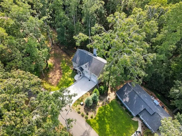 an aerial view of a house with a yard