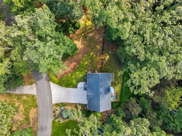 an aerial view of a house with garden space and sitting space