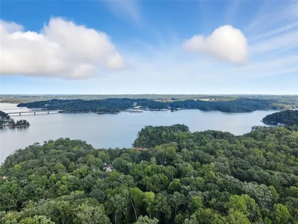 an aerial view of ocean with residential houses with outdoor space and seating