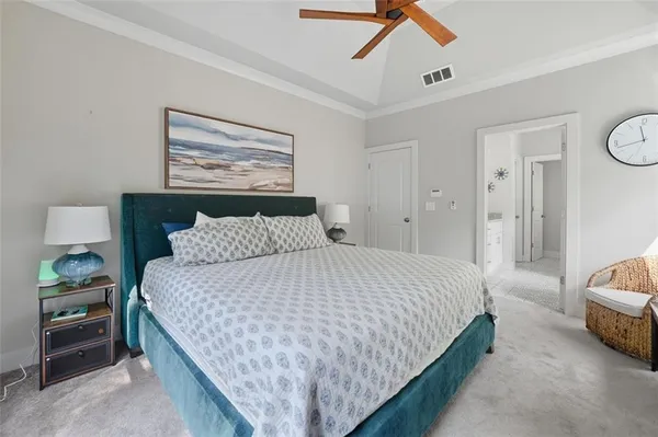 a bedroom with bed and a chandelier