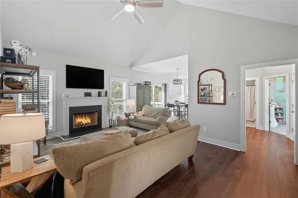 a living room with furniture a fireplace and a flat screen tv