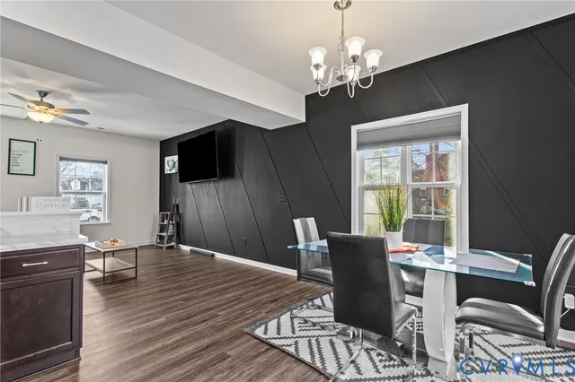 a dining room with furniture a chandelier and wooden floor