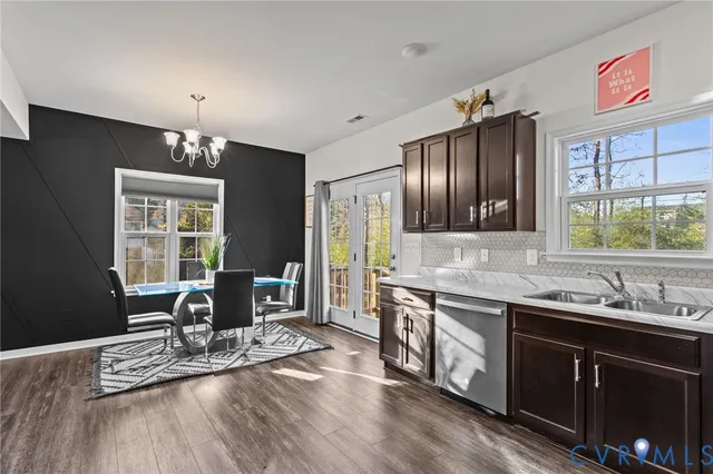 a kitchen with stainless steel appliances granite countertop a sink stove and wooden cabinets
