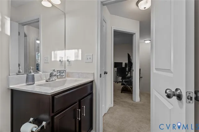 a bathroom with a sink vanity and a mirror