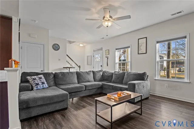 a living room with furniture and wooden floor