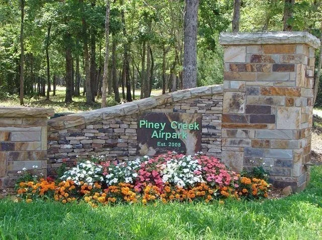 a view of a garden with flowers and trees