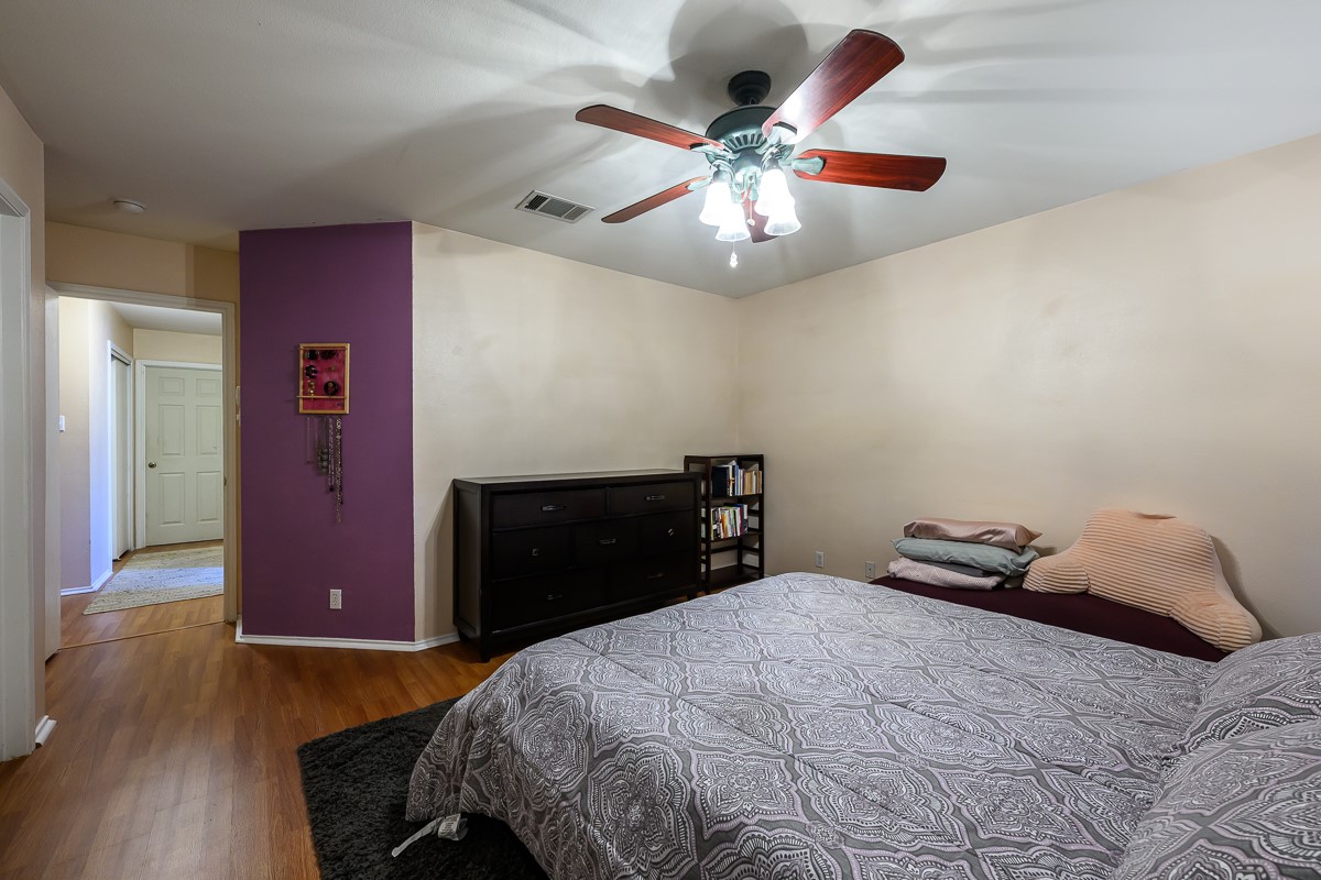 8920 Frock Court Austin, TX 78748 - Photo 11 of 22 a bedroom with a bed and a chandelier