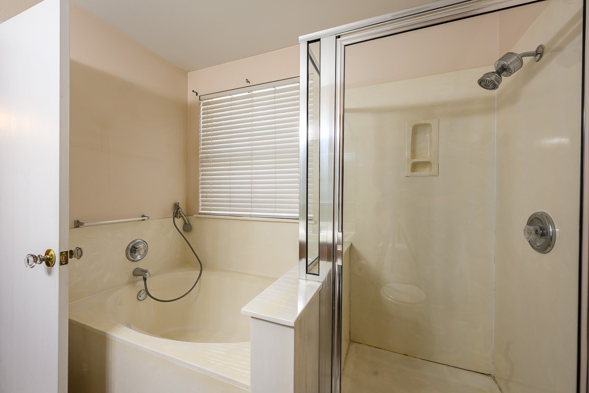 8920 Frock Court Austin, TX 78748 - Photo 14 of 22 a bathroom with a granite countertop sink a mirror and a shower