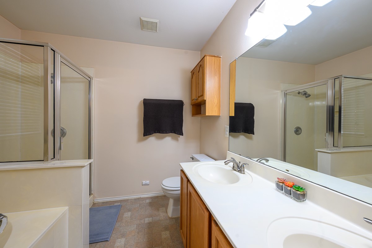8920 Frock Court Austin, TX 78748 - Photo 15 of 22 a bathroom with a sink a mirror and a shower