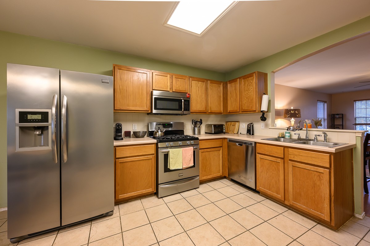 8920 Frock Court Austin, TX 78748 - Photo 7 of 22 a kitchen with stainless steel appliances granite countertop a refrigerator sink and stove
