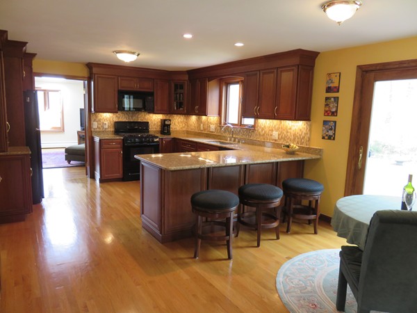 18 Nevada Road Tyngsborough, MA 01879 - Photo 2 of 22 a kitchen with stainless steel appliances granite countertop a stove top oven a dining table and chairs with wooden floor